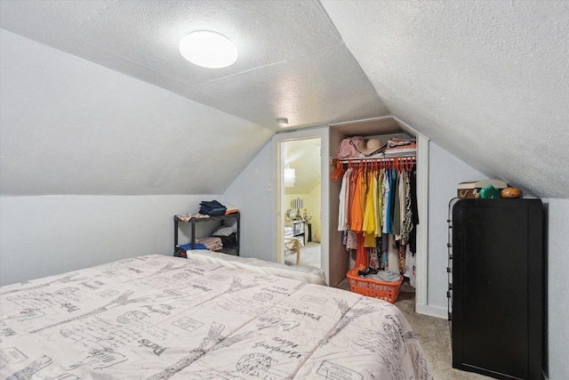 947 Cleveland St, Beloit, WI 53511 - bedroom with carpet flooring, a spacious closet, a textured ceiling, lofted ceiling, and a closet