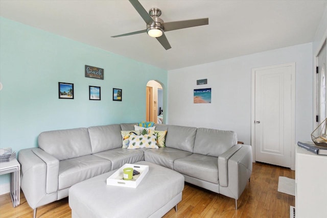 947 Cleveland St, Beloit, WI 53511 - living room featuring arched walkways, a ceiling fan, and light wood-style floors