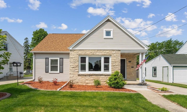 933 Higgins Ave, Neenah, WI 54956 - view of front of property with stone siding, a front lawn, an outdoor structure, a shingled roof, and a garage