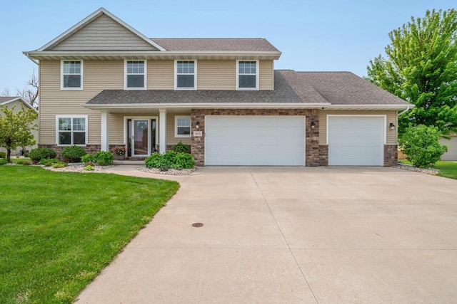 905 W Hubble Ln, Appleton, WI 54913 - view of front of property with concrete driveway, stone siding, a front yard, an attached garage, and roof with shingles