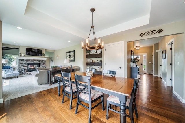 905 W Hubble Ln, Appleton, WI 54913 - dining area featuring hardwood / wood-style floors, a raised ceiling, a chandelier, a fireplace, and recessed lighting