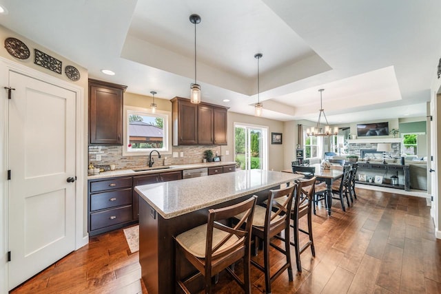 905 W Hubble Ln, Appleton, WI 54913 - kitchen featuring a raised ceiling, a sink, dark brown cabinetry, stainless steel dishwasher, and dark wood-type flooring