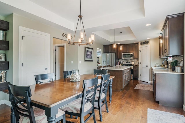 905 W Hubble Ln, Appleton, WI 54913 - dining space with a raised ceiling, dark wood-style flooring, a chandelier, and recessed lighting