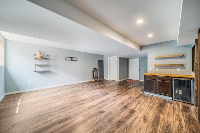 905 W Hubble Ln, Appleton, WI 54913 - unfurnished living room featuring beverage cooler, a dry bar, wood finished floors, baseboards, and recessed lighting