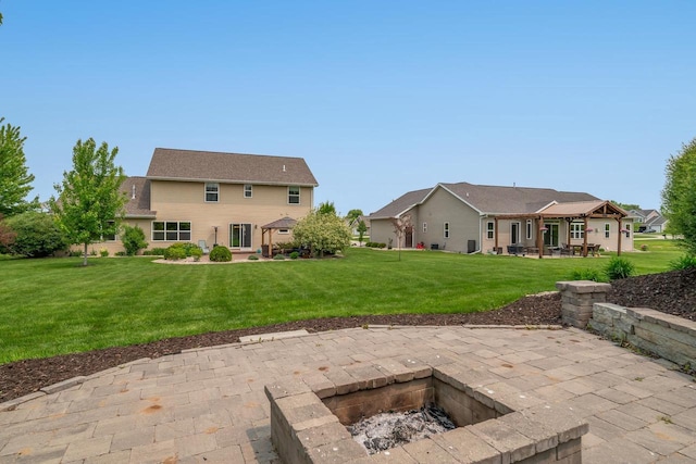 905 W Hubble Ln, Appleton, WI 54913 - rear view of house with an outdoor fire pit, a patio, and a lawn