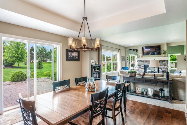 905 W Hubble Ln, Appleton, WI 54913 - dining area featuring dark wood-type flooring, a chandelier, and a fireplace