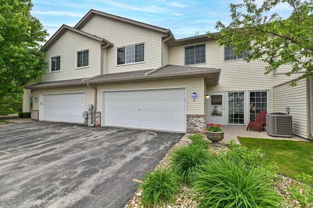 2425 Fox River Pkwy Unit H, Waukesha, WI 53189 - view of front of property with driveway, central AC, a garage, and brick siding