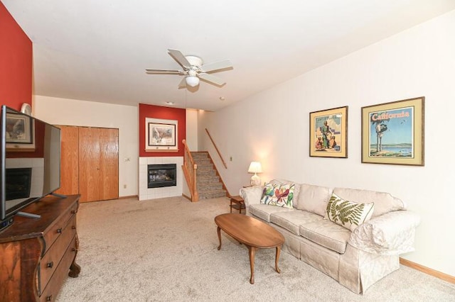 2425 Fox River Pkwy Unit H, Waukesha, WI 53189 - living room featuring a fireplace, light colored carpet, a ceiling fan, and stairs