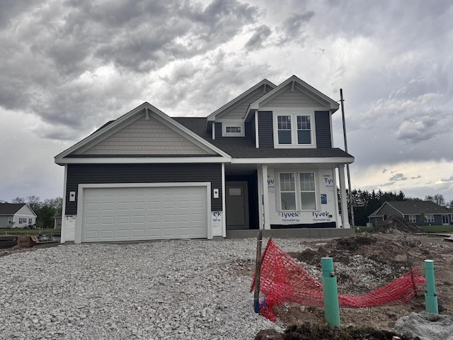 4404 20th St, Kenosha, WI 53144 - view of front facade with a porch, gravel driveway, and a garage