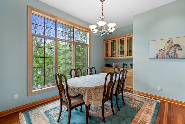W3847 Timber Lake Rd, East Troy, WI 53120 - dining area with a chandelier, plenty of natural light, baseboards, and wood finished floors