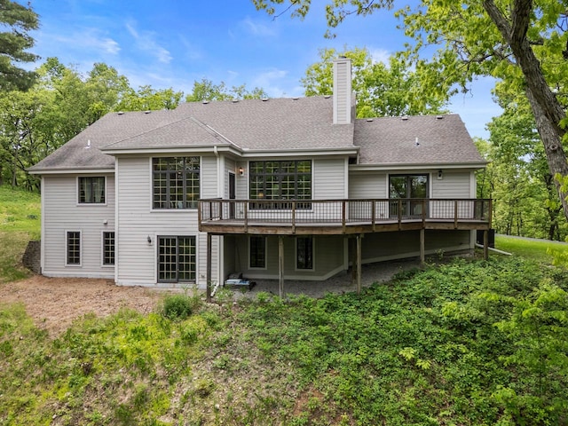 W3847 Timber Lake Rd, East Troy, WI 53120 - rear view of property featuring a chimney, a wooden deck, and roof with shingles