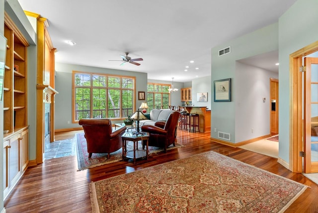 W3847 Timber Lake Rd, East Troy, WI 53120 - living area featuring a ceiling fan, dark wood-style floors, a chandelier, baseboards, and recessed lighting
