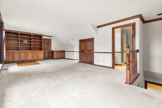 28 W Lake Rd, Menasha, WI 54952 - unfurnished living room with crown molding, light carpet, baseboards, and vaulted ceiling