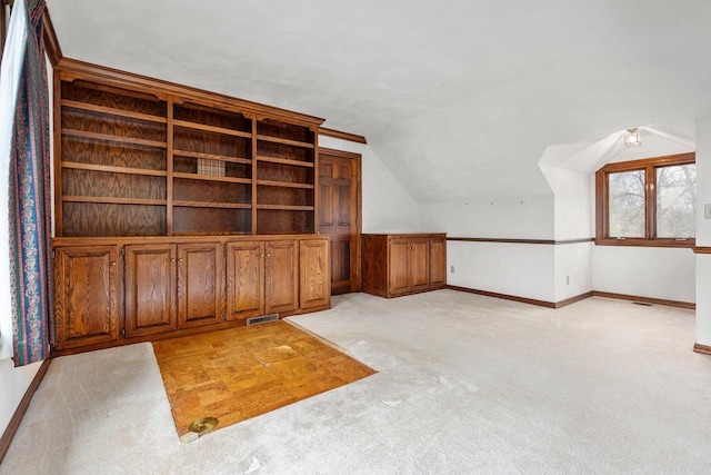 28 W Lake Rd, Menasha, WI 54952 - additional living space with lofted ceiling, light carpet, and baseboards