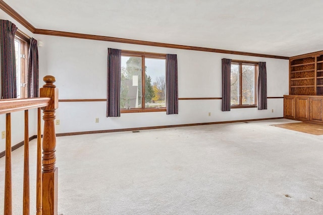 28 W Lake Rd, Menasha, WI 54952 - unfurnished living room featuring carpet flooring, ornamental molding, built in features, and baseboards