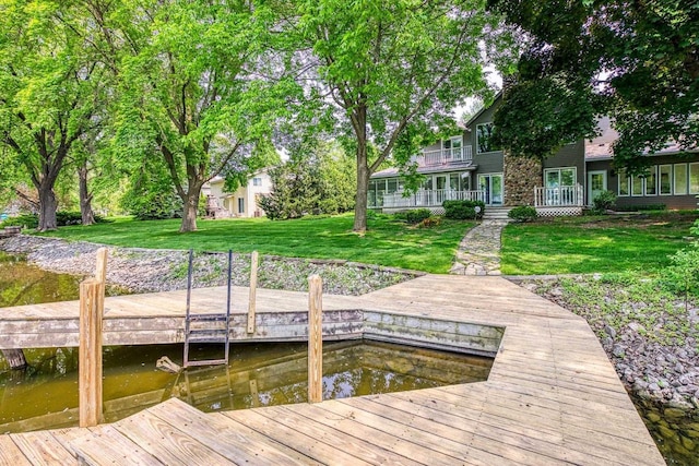 28 W Lake Rd, Menasha, WI 54952 - dock featuring a yard, a water view, and a balcony