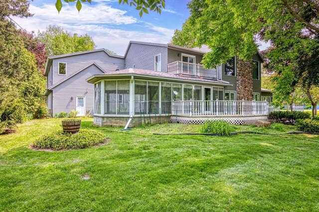 28 W Lake Rd, Menasha, WI 54952 - back of house with a balcony, a sunroom, and a lawn