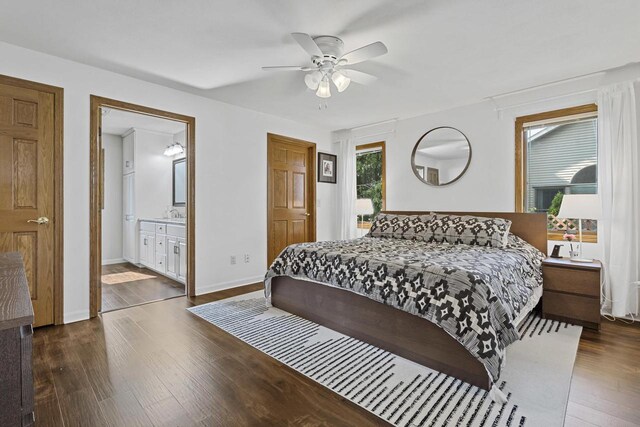 1323 Bradford Ct, Neenah, WI 54956 - bedroom with wood finished floors, baseboards, ensuite bath, and ceiling fan
