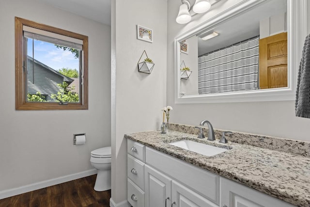 1323 Bradford Ct, Neenah, WI 54956 - bathroom with vanity, baseboards, toilet, and wood finished floors