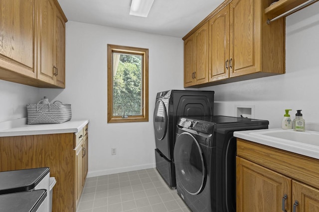1323 Bradford Ct, Neenah, WI 54956 - laundry room with washer and clothes dryer, cabinet space, and baseboards