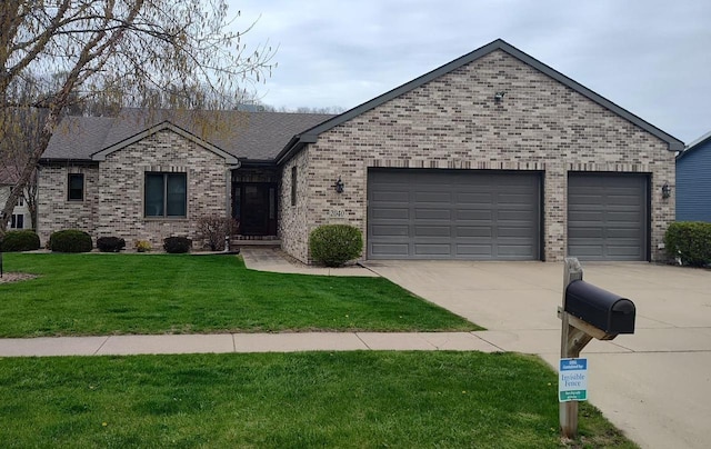 2040 Continental Ln, Cross Plains, WI 53528 - ranch-style house with driveway, brick siding, a garage, and a front lawn