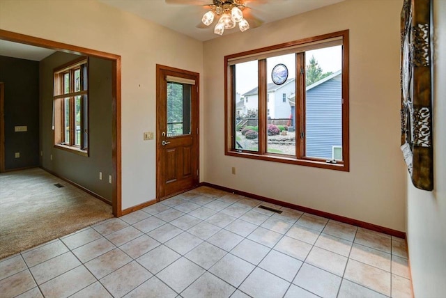 2040 Continental Ln, Cross Plains, WI 53528 - entryway with plenty of natural light, a ceiling fan, light tile patterned floors, and light carpet