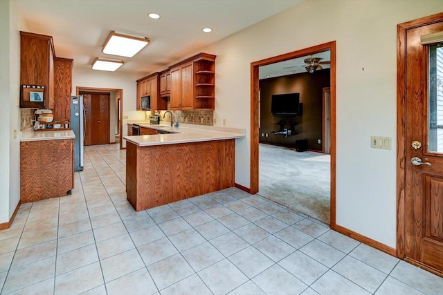 2040 Continental Ln, Cross Plains, WI 53528 - kitchen featuring open shelves, light countertops, stainless steel appliances, brown cabinets, and light tile patterned floors
