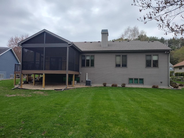 2040 Continental Ln, Cross Plains, WI 53528 - rear view of house with a yard, a chimney, a sunroom, and a patio area