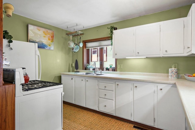 129 Division St, Madison, WI 53704 - kitchen with white appliances, white cabinets, light countertops, and light flooring