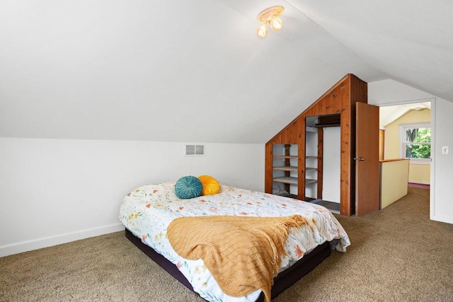 129 Division St, Madison, WI 53704 - carpeted bedroom featuring lofted ceiling and baseboards