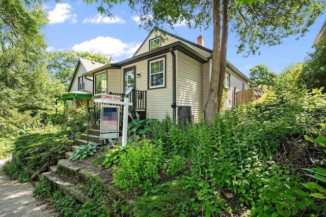 129 Division St, Madison, WI 53704 - view of side of home featuring a chimney and stairs