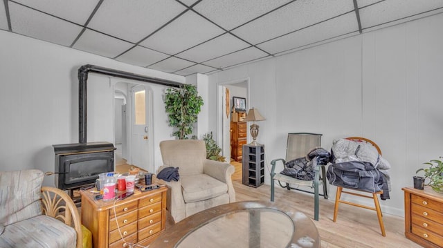 613 N 5th St Unit 611, Sheboygan, WI 53081 - sitting room with a paneled ceiling, light wood-style flooring, and a wood stove