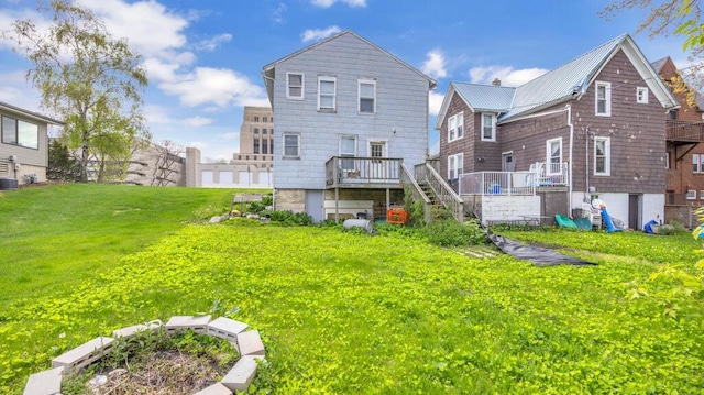 613 N 5th St Unit 611, Sheboygan, WI 53081 - rear view of house with stairway, a wooden deck, a lawn, and central air condition unit