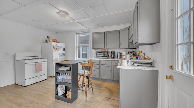 613 N 5th St Unit 611, Sheboygan, WI 53081 - kitchen with white appliances, gray cabinetry, light countertops, and plenty of natural light
