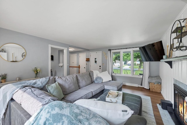 3813 S Clay St, Green Bay, WI 54301 - living room featuring a fireplace, wood finished floors, and baseboards