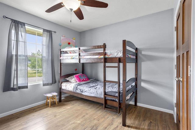 763 Severndroog Way, Howard, WI 54313 - bedroom featuring multiple windows, wood finished floors, baseboards, and a ceiling fan