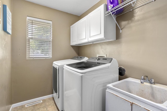 763 Severndroog Way, Howard, WI 54313 - laundry area with washer and dryer, baseboards, cabinet space, and light tile patterned floors