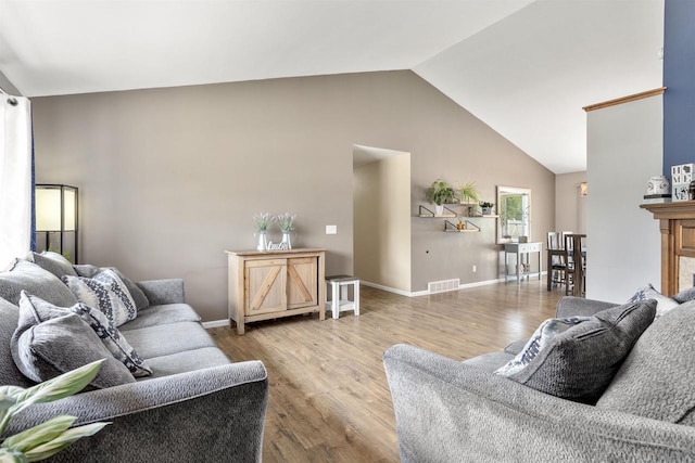 763 Severndroog Way, Howard, WI 54313 - living room featuring wood finished floors, high vaulted ceiling, and baseboards