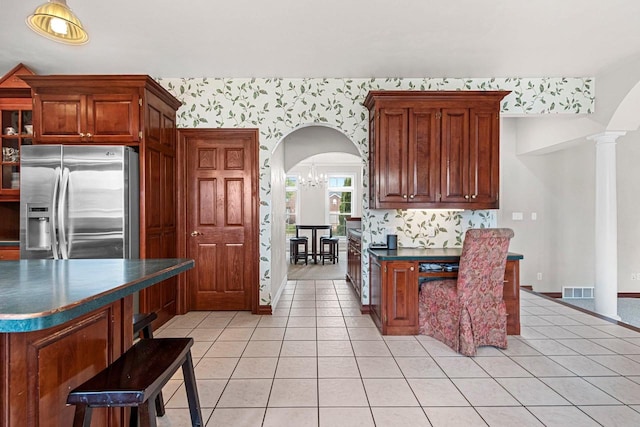 139 Sullivan Ln, De Pere, WI 54115 - kitchen featuring stainless steel refrigerator with ice dispenser, arched walkways, dark countertops, wallpapered walls, and light tile patterned floors