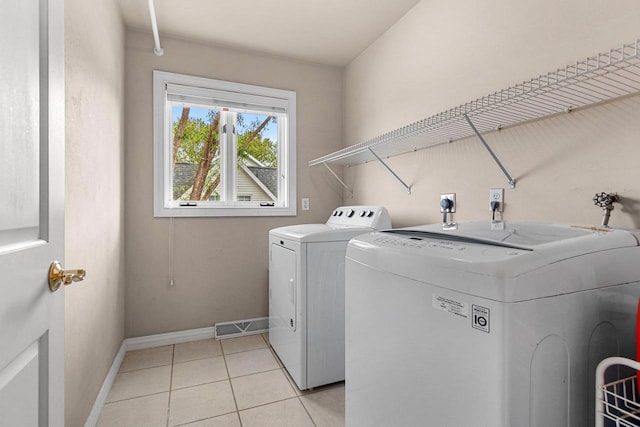 139 Sullivan Ln, De Pere, WI 54115 - laundry area featuring washing machine and dryer, baseboards, and light tile patterned flooring
