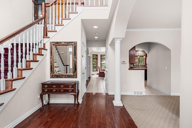 139 Sullivan Ln, De Pere, WI 54115 - entryway with arched walkways, wood-type flooring, stairway, baseboards, and ornamental molding