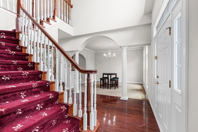 139 Sullivan Ln, De Pere, WI 54115 - entryway featuring arched walkways, stairway, a chandelier, wood-type flooring, and decorative columns