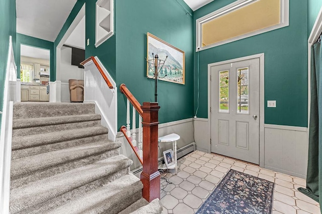 1123 S Park Ave, Neenah, WI 54956 - foyer featuring a wainscoted wall, stairs, tile patterned floors, and a baseboard heating unit