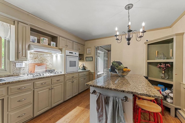 1123 S Park Ave, Neenah, WI 54956 - kitchen featuring open shelves, white oven, stainless steel gas cooktop, under cabinet range hood, and a chandelier