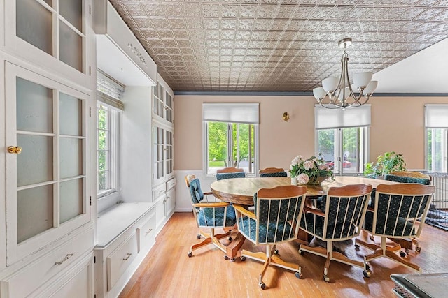 1123 S Park Ave, Neenah, WI 54956 - dining space featuring an ornate ceiling, a chandelier, light wood finished floors, and ornamental molding