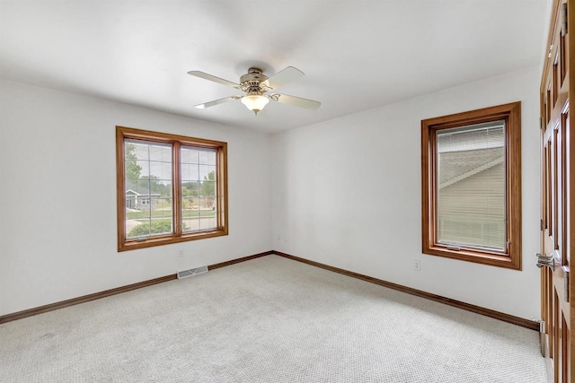 1411 Cocos, Green Bay, WI 54313 - spare room featuring light colored carpet, baseboards, and a ceiling fan