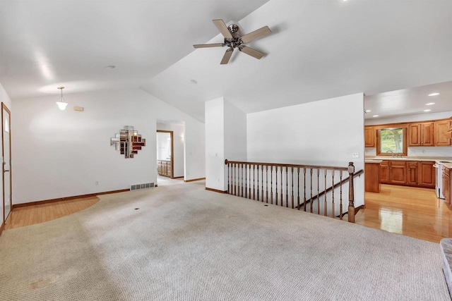 1411 Cocos, Green Bay, WI 54313 - unfurnished living room with vaulted ceiling, a ceiling fan, light carpet, baseboards, and recessed lighting