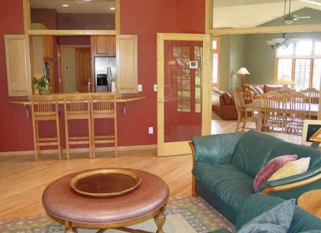 10 Vienna Cir, Madison, WI 53718 - living room featuring wood finished floors, a ceiling fan, and french doors