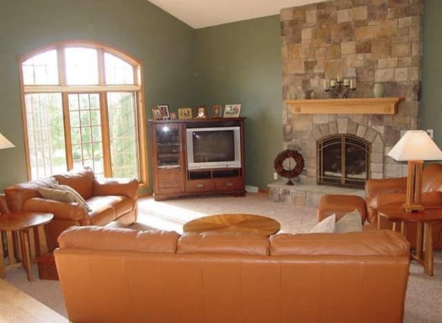 10 Vienna Cir, Madison, WI 53718 - carpeted living room featuring plenty of natural light, a fireplace, and vaulted ceiling