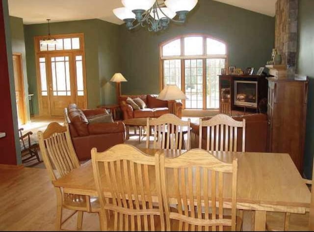 10 Vienna Cir, Madison, WI 53718 - dining room featuring a chandelier, healthy amount of natural light, wood finished floors, and lofted ceiling